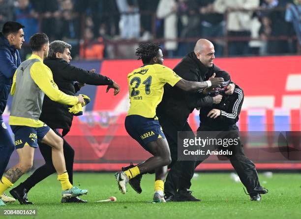 Players of Fenerbahce encounter with a supporter, who enters to the pitch, after the Turkish Super Lig week 30 football match between Trabzonspor and...