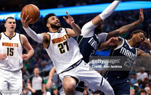 Jamal Murray of the Denver Nuggets goes inside for a shot against the Dallas Mavericks in the first half at American Airlines Center on March 17,...