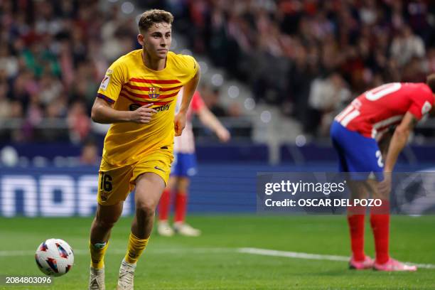Barcelona's Spanish midfielder Fermin Lopez celebrates scoring his team's third goal during the Spanish league football match between Club Atletico...