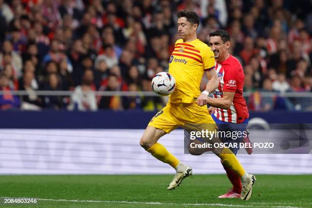 Barcelona's Polish forward Robert Lewandowski vies with Atletico Madrid's Montenegrin defender Stefan Savic during the Spanish league football match...