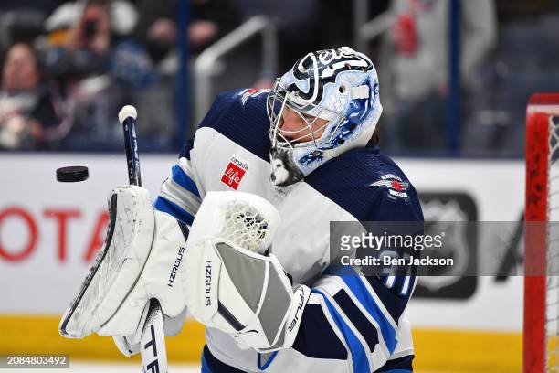 Goaltender Connor Hellebuyck of the Winnipeg Jets warms up prior to a game against the Columbus Blue Jackets at Nationwide Arena on March 17, 2024 in...