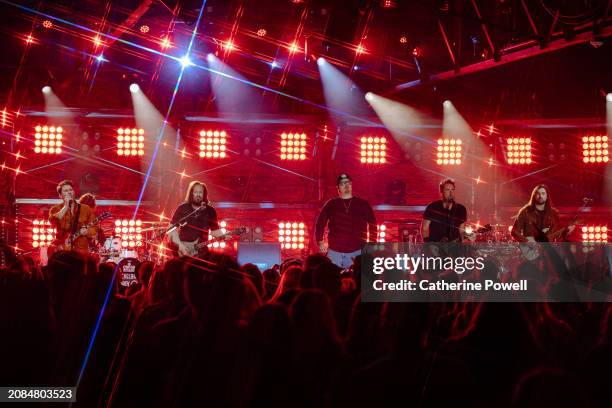 Ryan Peake of Nickelback, Justin Loose, HARDY, Chad Kroeger of Nickelback and Rhett Smith perform at CMT Crossroads: Nickelback & HARDY at Marathon...