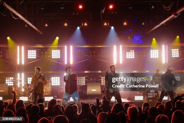 Ryan Peake of Nickelback, HARDY, and Chad Kroeger, Daniel Adair and Mike Kroeger of Nickelback perform at CMT Crossroads: Nickelback & HARDY at...