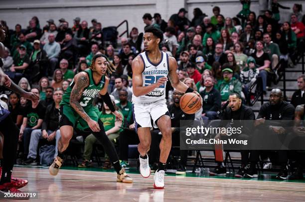 March 17: Jaylen Sims of the Greensboro Swarm handles the ball during the game against the Maine Celtics on March 17, 2024 at Portland Expo Center in...