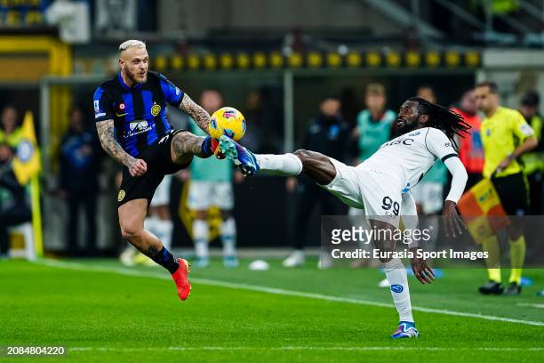 Federico Dimarco of Internazionale trips up with André-Frank Zambo Anguissa of Napoli during the Serie A TIM match between FC Internazionale and SSC...