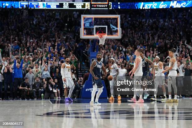 Kyrie Irving of the Dallas Mavericks celebrates during the game after scoring the game winning basket against the Denver Nuggets on March 17, 2024 at...