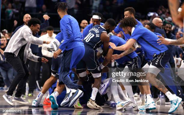 The Dallas Mavericks celebrate after Kyrie Irving of the Dallas Mavericks made a last second game winning shot against the Denver Nuggets at American...