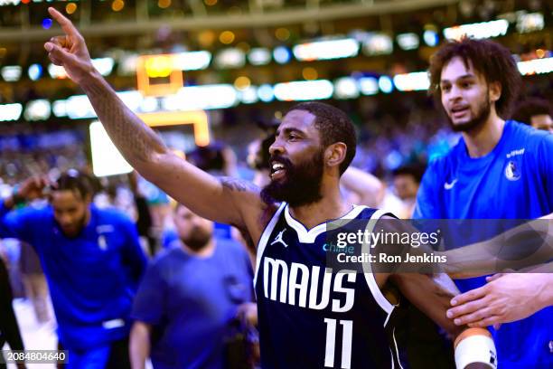 Kyrie Irving of the Dallas Mavericks celebrates after hitting the game winning shot against the Denver Nuggets at American Airlines Center on March...