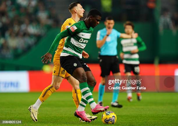 Ousmane Diomande of Sporting CP with Robert Bozenik of Boavista FC in action during the Liga Portugal Betclic match between Sporting CP and Boavista...