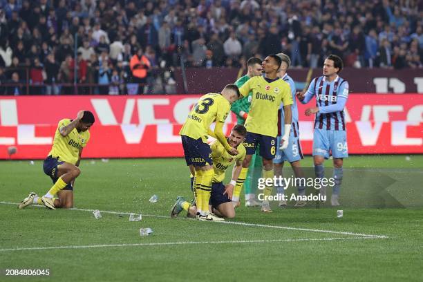 Players of Fenerbahce try to protect themselves from objects, threw on the pitch, during the Turkish Super Lig week 30 football match between...
