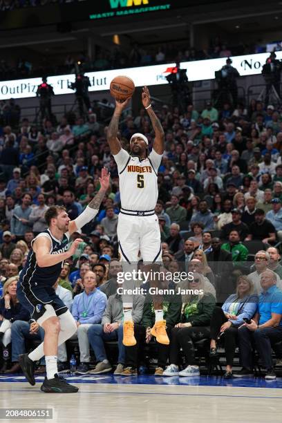 Kentavious Caldwell-Pope of the Denver Nuggets shoots the ball during the game against the Dallas Mavericks on March 17, 2024 at the American...