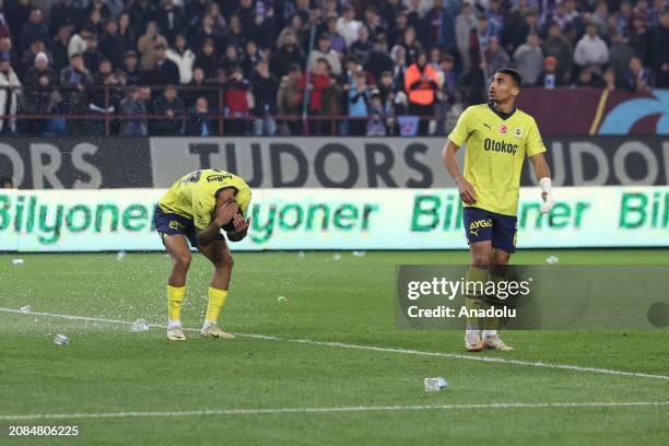 Players of Fenerbahce try to protect themselves from objects, threw on the pitch, during the Turkish Super Lig week 30 football match between...