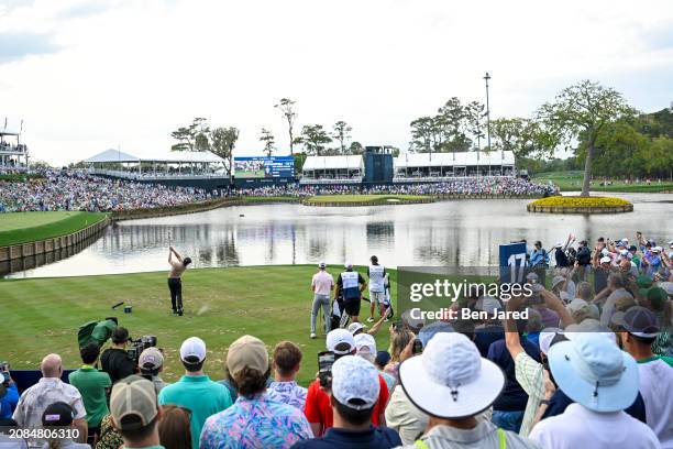 Xander Schauffele plays a shot from the 17th tee during the final round of THE PLAYERS Championship at Stadium Course at TPC Sawgrass on March 17,...