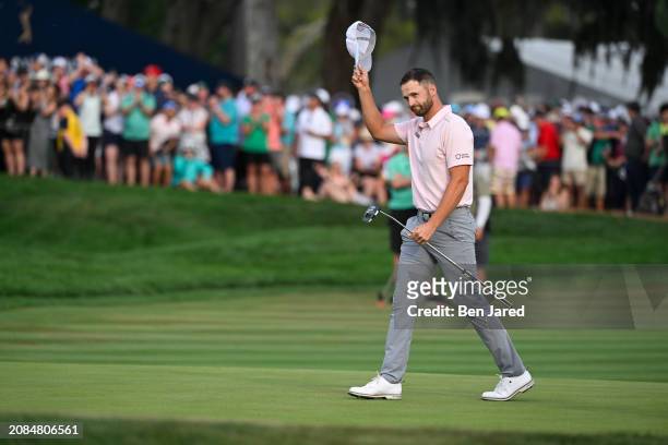 Wyndham Clark waves on the 18th green during the final round of THE PLAYERS Championship at Stadium Course at TPC Sawgrass on March 17, 2024 in Ponte...