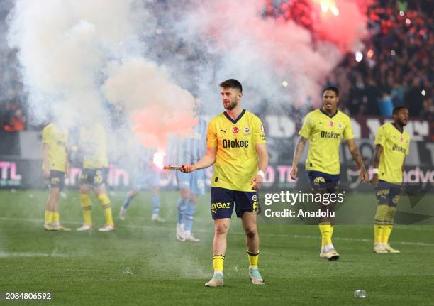 Ismail Yuksek of Fenerbahce holds an object, threw on the pitch, during the Turkish Super Lig week 30 football match between Trabzonspor and...