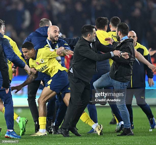 Security officers take measure as a brawl break out between players of Fenerbahce and supporters, who enter the pitch, after the Turkish Super Lig...