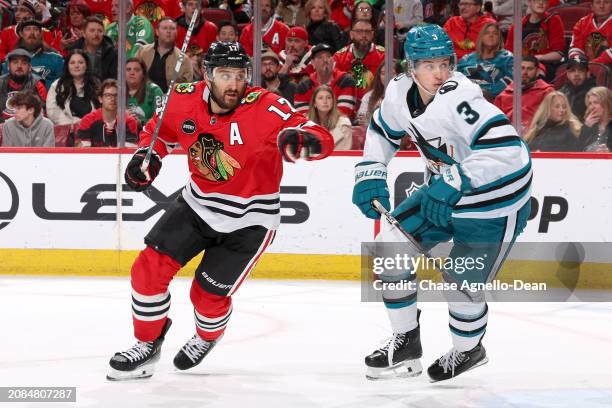 Nick Foligno of the Chicago Blackhawks and Henry Thrun of the San Jose Sharks skate in the second period at the United Center on March 17, 2024 in...