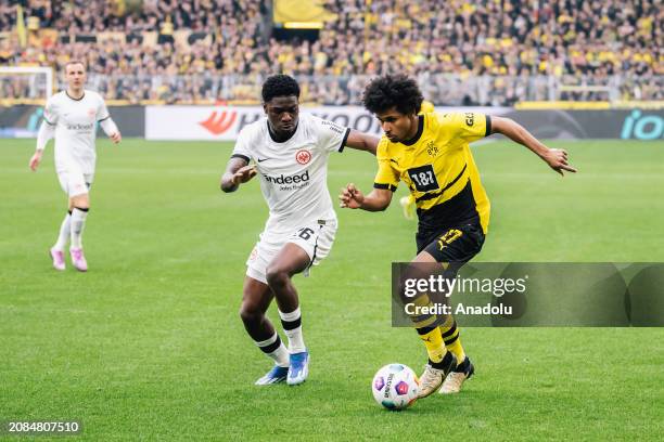 Karim Adeyemi of Borussia Dortmund and Junior Dina Ebimbe of Eintracht Frankfurt in action during the Bundesliga football match between Borussia...