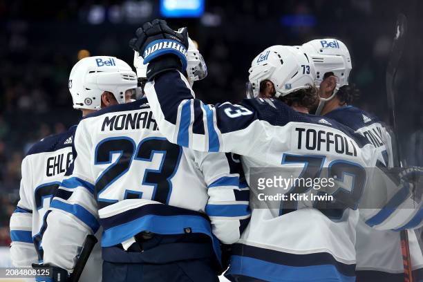 Tyler Toffoli of the Winnipeg Jets is congratulated by his teammates after scoring a goal during the third period of the game against the Columbus...