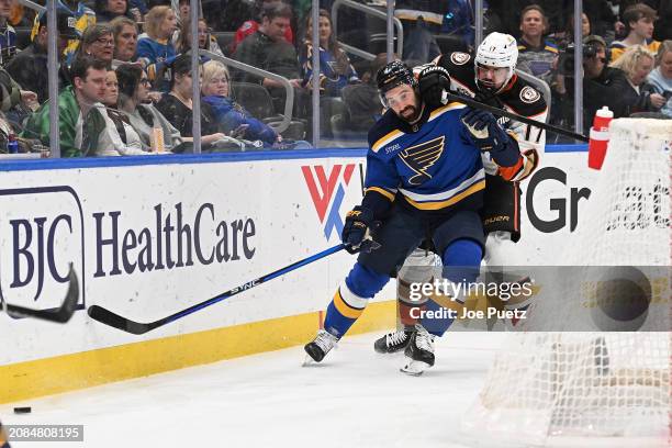 Alex Killorn of the Anaheim Ducks battles Nick Leddy of the St. Louis Blues for the puck on March 17, 2024 at the Enterprise Center in St. Louis,...