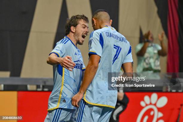 Atlanta midfielder Saba Lobzhanidze and teammate Giorgos Giakoumakis react after scoring a first-half goal during the MLS match between Orlando City...