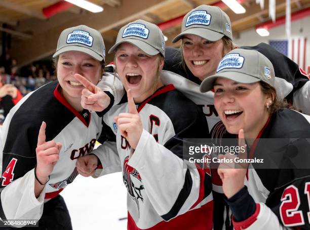 Wisconsin-River Falls Falcons players celebrate and pose for photos at the Division III Women's Ice Hockey Championship held at Hunt Arena on March...