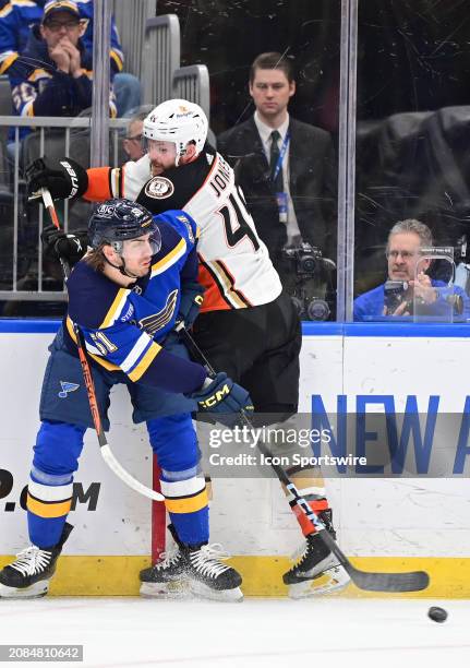 St. Louis Blues defenseman Matthew Kessel and Anaheim Ducks leftwing Max Jones battle for the puck during a NHL game between the Anaheim Ducks and...