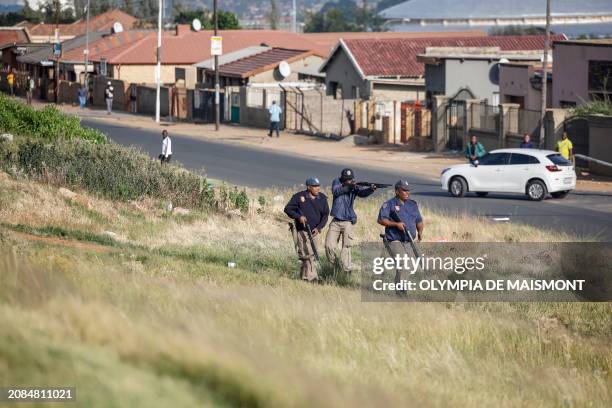 Johannesburg Metro Police Department officers fire rubber bullets to disperse protesters during a service delivery protest in Diepkloof, near...