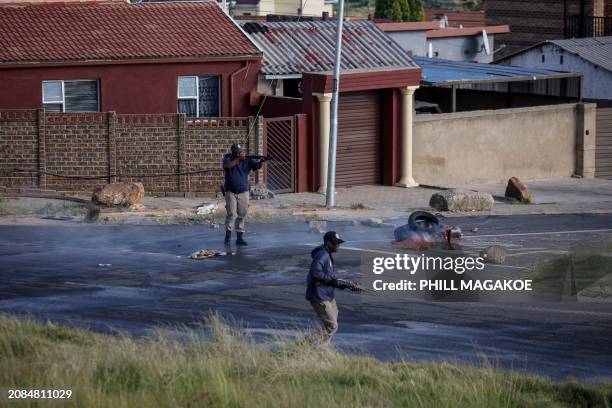 Johannesburg Metro Police Department officers fire rubber bullets at residents during a service delivery protest in Diepkloof, near Johannesburg, on...