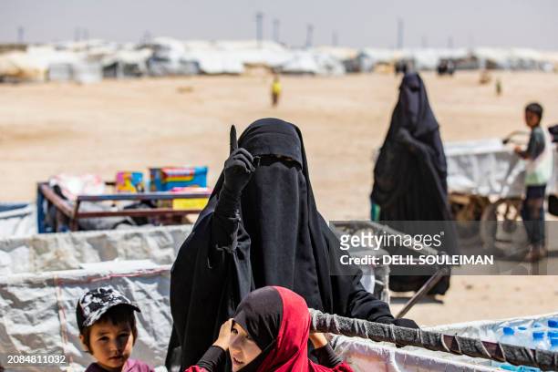 Woman gestures while standing at the al-Hol camp in Syria's northeastern Al-Hasakah Governorate, on October 10, 2023. The al-Hol camp is the largest...