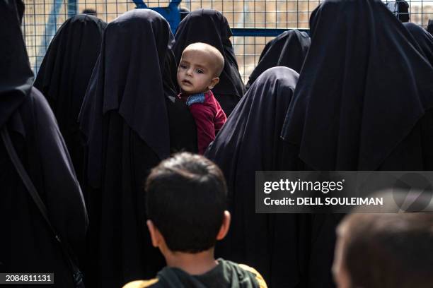 Women stand next to a fence at the al-Hol camp in Syria's northeastern Al-Hasakah Governorate, on October 10, 2023. The al-Hol camp is the largest of...
