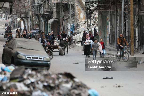 Palestinian residents leave the area with a few items after the Israeli army forces besiege the Al-Shifa hospital with tanks and heavy gunfire in...