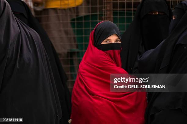 Girl looks on as she stands next to a fence at the al-Hol camp in Syria's northeastern Al-Hasakah Governorate, on October 11, 2023. The al-Hol camp...