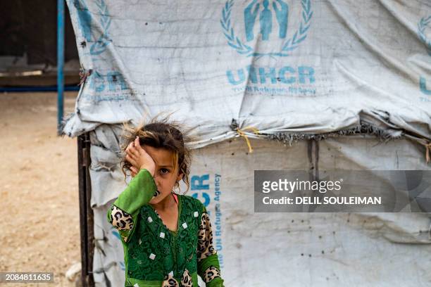 Girl rubs her eye at the al-Hol camp in Syria's northeastern Al-Hasakah Governorate, on October 10, 2023. The al-Hol camp is the largest of two in...