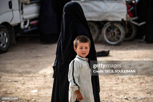 Woman stands with her child at the al-Hol camp in Syria's northeastern Al-Hasakah Governorate, on October 11, 2023. The al-Hol camp is the largest of...