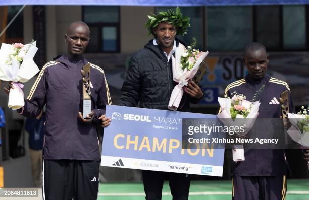 Gold medalist Jemal Yimer Mekonnen C of Ethiopia, silver medalist Rhonzas Lokitam Kilimo L of Kenya and bronze medalist Edwin Kiprop Kiptoo of Kenya...