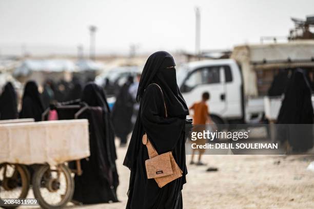 Women walk through the al-Hol camp in Syria's northeastern Al-Hasakah Governorate, on October 11, 2023. The al-Hol camp is the largest of two in...
