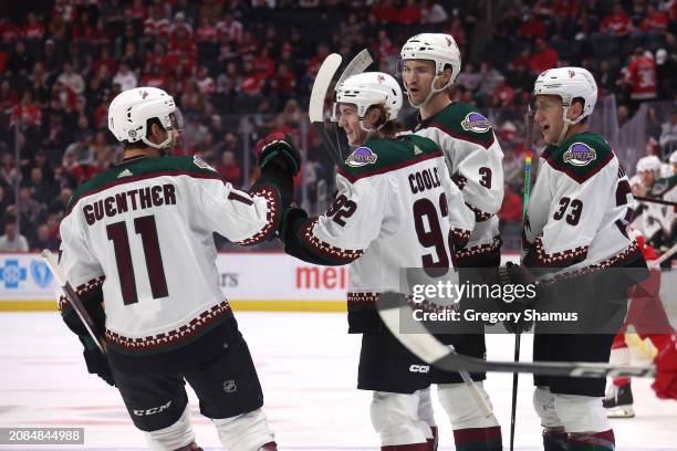 Logan Cooley of the Arizona Coyotes celebrates his first period goal with teammates while playing the Detroit Red Wings at Little Caesars Arena on...