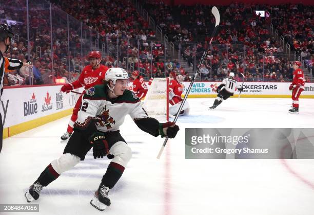 Logan Cooley of the Arizona Coyotes celebrates his first period goal in front of Alex Lyon of the Detroit Red Wings at Little Caesars Arena on March...