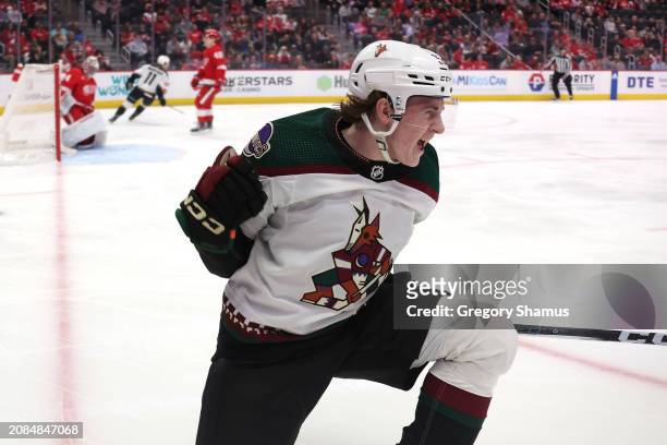 Logan Cooley of the Arizona Coyotes celebrates his first period goal in front of Alex Lyon of the Detroit Red Wings at Little Caesars Arena on March...