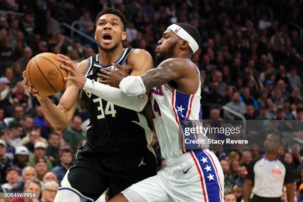 Giannis Antetokounmpo of the Milwaukee Bucks is fouled by Paul Reed of the Philadelphia 76ers during the first half of a game at Fiserv Forum on...