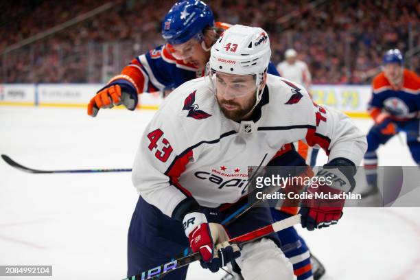 Tom Wilson of the Washington Capitals battles against Vincent Desharnais of the Edmonton Oilers during the first period at Rogers Place on March 13,...