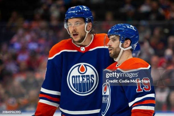 Adam Henrique and Vincent Desharnais of the Edmonton Oilers talk between the play against the Washington Capitals during the third period at Rogers...