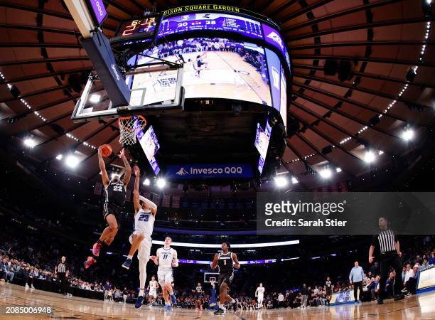 Devin Carter of the Providence Friars goes to the basket as Trey Alexander of the Creighton Bluejays defends in the first half during the...