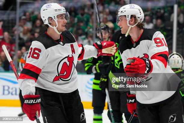 Dawson Mercer of the New Jersey Devils celebrates his second period goal against the Dallas Stars with Jack Hughes at American Airlines Center on...