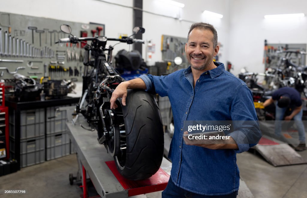 Business owner smiling at a motorcycle repair shop