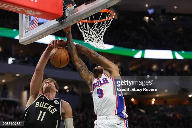 Brook Lopez of the Milwaukee Bucks blocks a shot by Kelly Oubre Jr. #9 of the Philadelphia 76ers during the second half of a game at Fiserv Forum on...