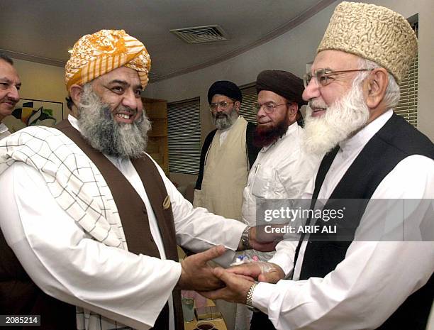 Pakistan's Six party religious Islamic alliance Muttahida Majlis-e-Amal leader Qazi Hussain Ahmed greets Mualana Fazlur Rehman , Shah Ahmed Noorani...