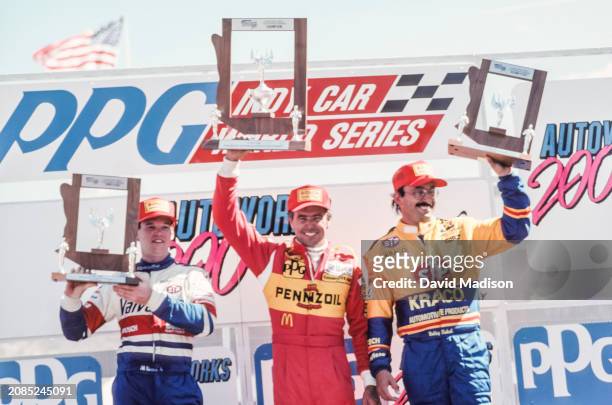 Al Unser Jr of the USA and Galles-Kraco Racing, Rick Mears of the USA and Team Penske, and Bobby Rahal of the USA and Galles-Kraco Racing celebrate...