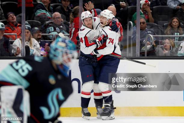 Connor McMichael celebrates his goal with John Carlson of the Washington Capitals during the third period against the Seattle Kraken at Climate...